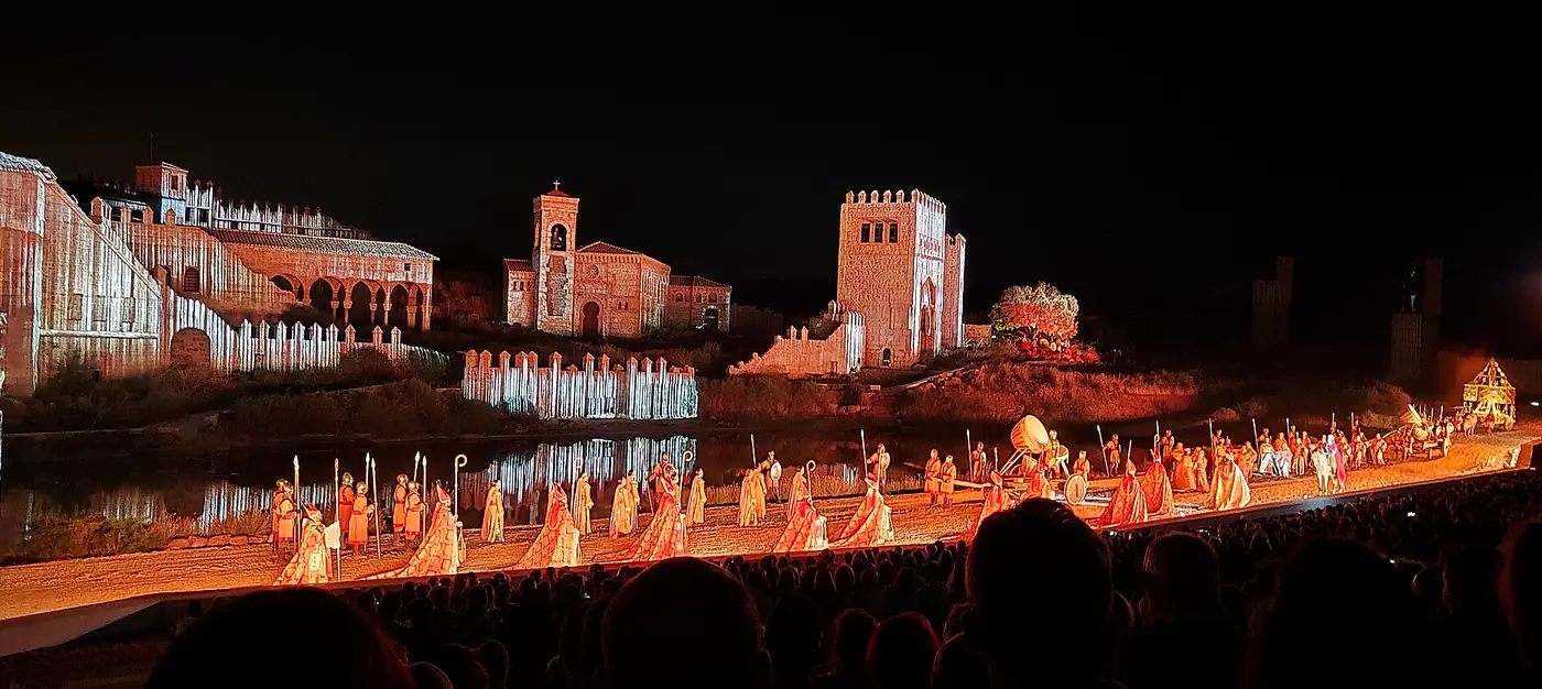 Panorámica nocturna del espectáculo El Sueño de Toledo en Puy du Fou España, con el escenario iluminado